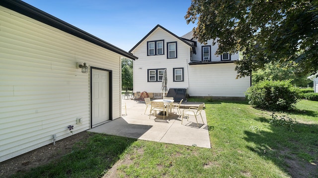 215 E 3rd St, Byron, IL 61010 - back of property featuring a yard and a patio