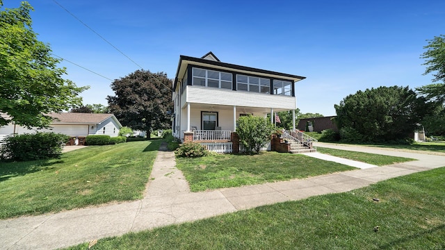 215 E 3rd St, Byron, IL 61010 - view of front facade with a front yard and a porch