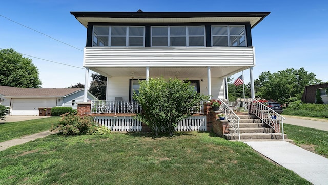 215 E 3rd St, Byron, IL 61010 - view of front of house featuring covered porch and a front yard