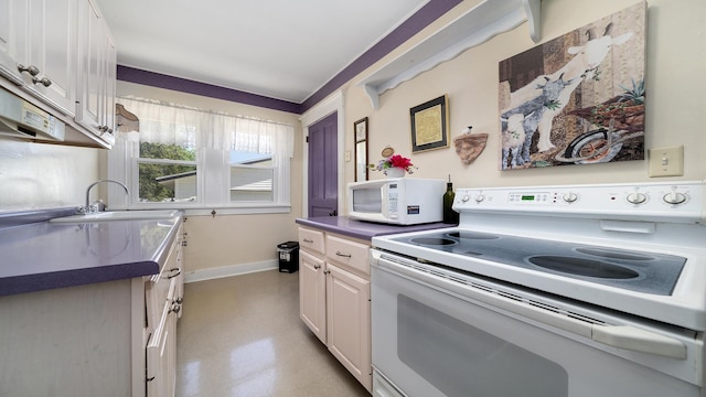 215 E 3rd St, Byron, IL 61010 - kitchen featuring white appliances, white cabinetry, and dark countertops