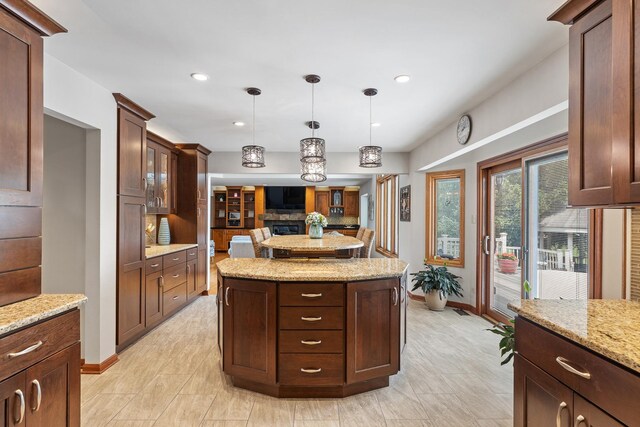 9901 Mission, Palos Park, IL 60464 - kitchen with hanging light fixtures, light stone counters, a center island, glass insert cabinets, and recessed lighting