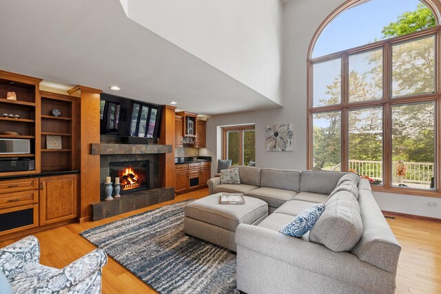 9901 Mission, Palos Park, IL 60464 - living room featuring a tiled fireplace, plenty of natural light, light wood-style floors, a high ceiling, and recessed lighting