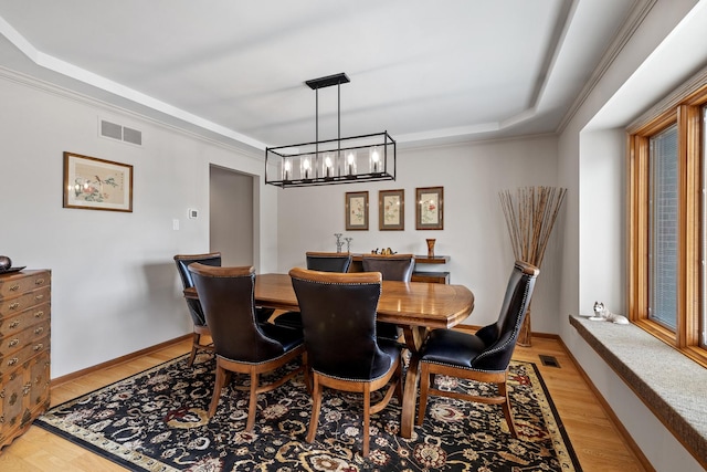 9901 Mission, Palos Park, IL 60464 - dining room with light wood-type flooring, a raised ceiling, a chandelier, and crown molding