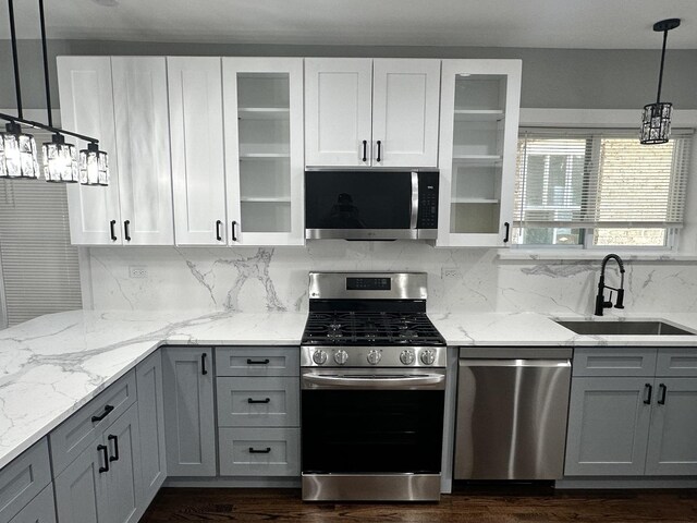 5426 N Bernard St, Chicago, IL 60625 - kitchen with stainless steel appliances, dark wood finished floors, tasteful backsplash, and gray cabinets