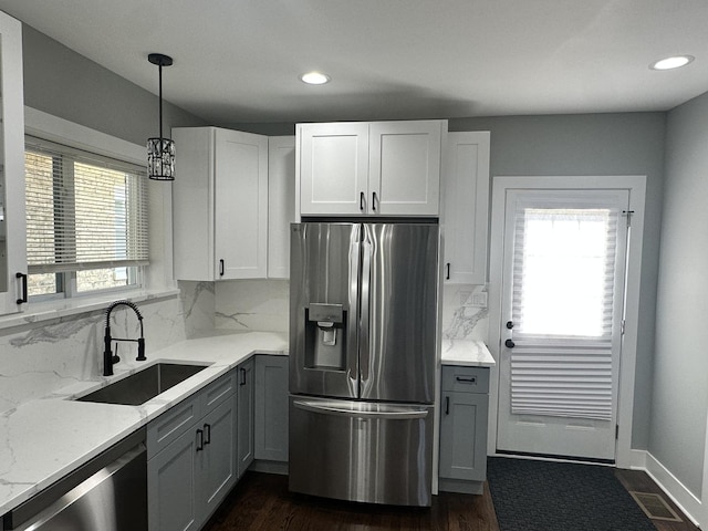 5426 N Bernard St, Chicago, IL 60625 - kitchen with stainless steel appliances, backsplash, recessed lighting, light stone countertops, and white cabinetry