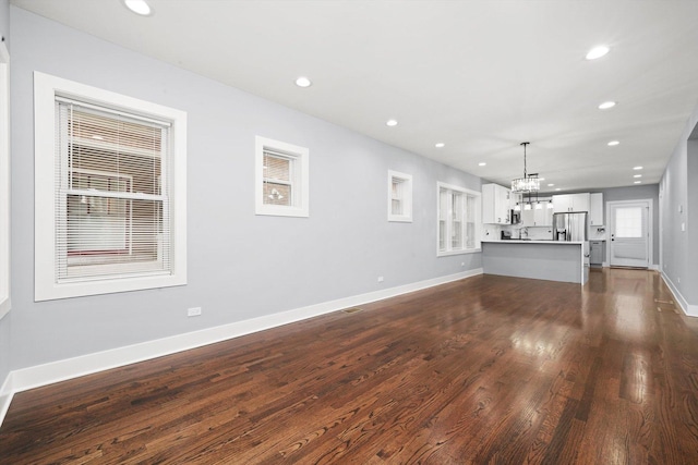 5426 N Bernard St, Chicago, IL 60625 - unfurnished living room with a chandelier, recessed lighting, and dark wood-style floors