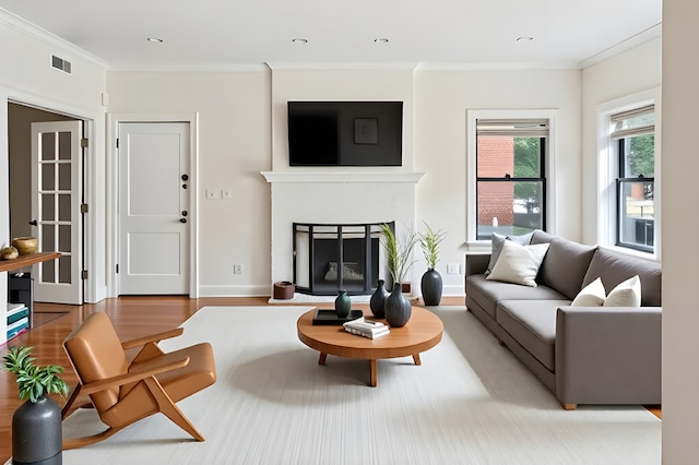 4023 N Southport Ave Unit 1, Chicago, IL 60613 - living room with a fireplace with raised hearth, crown molding, and light wood-type flooring