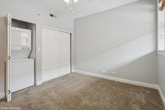 4023 N Southport Ave Unit 1, Chicago, IL 60613 - unfurnished bedroom featuring estacked washer and dryer, carpet floors, a closet, and ceiling fan