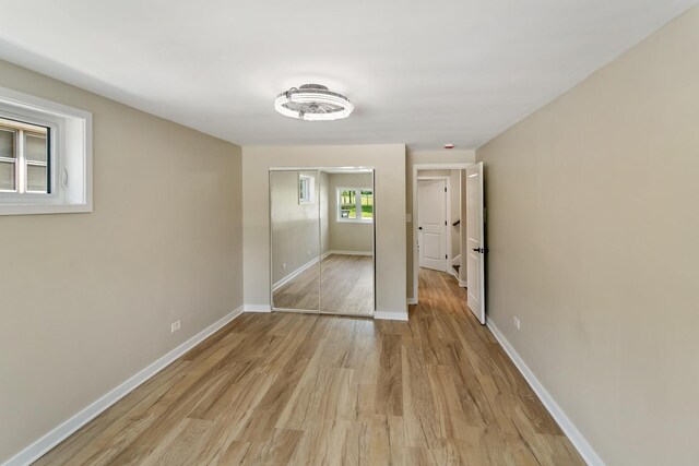 2637 W 93rd Pl, Evergreen Park, IL 60805 - unfurnished bedroom featuring light wood-style flooring and a closet