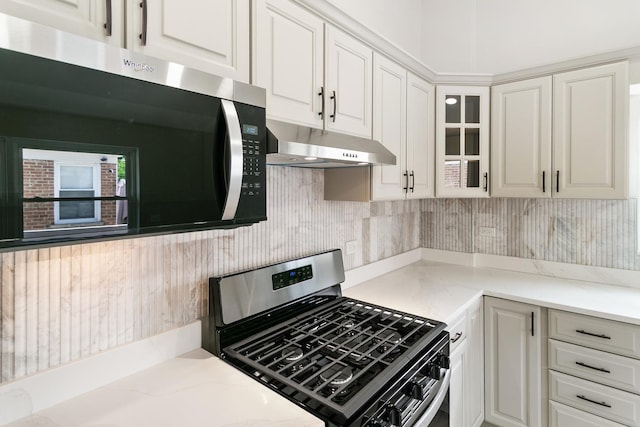 2637 W 93rd Pl, Evergreen Park, IL 60805 - kitchen featuring appliances with stainless steel finishes, under cabinet range hood, backsplash, white cabinetry, and glass insert cabinets