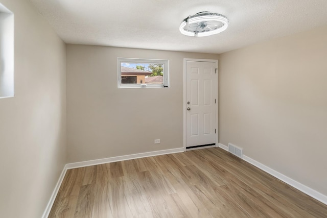 2637 W 93rd Pl, Evergreen Park, IL 60805 - unfurnished room featuring light wood-style flooring and a textured ceiling