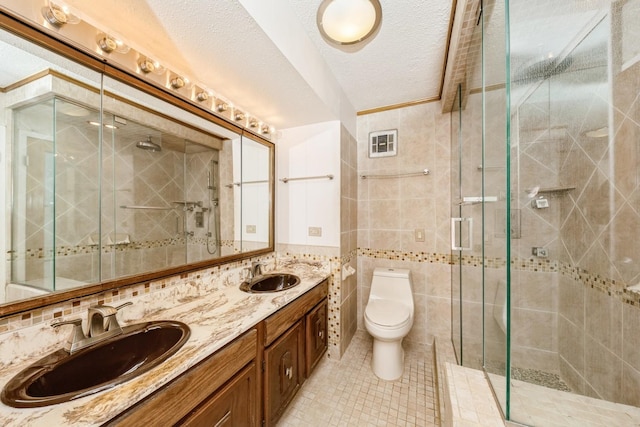 5471 S Hyde Park Blvd Unit 16Ab, Chicago, IL 60615 - bathroom featuring a shower stall, tile patterned floors, double vanity, tile walls, and a textured ceiling