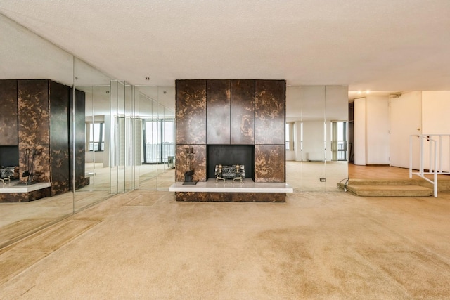 5471 S Hyde Park Blvd Unit 16Ab, Chicago, IL 60615 - unfurnished living room with a tiled fireplace, carpet, and a textured ceiling