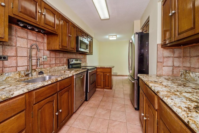 5471 S Hyde Park Blvd Unit 16Ab, Chicago, IL 60615 - kitchen featuring stainless steel appliances, decorative backsplash, and brown cabinets