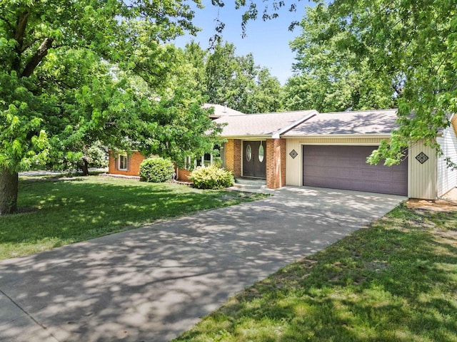 1106 Countryside Ln, Pontiac, IL 61764 - view of front facade with a garage, concrete driveway, a front yard, and brick siding