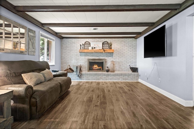 1106 Countryside Ln, Pontiac, IL 61764 - living room with wood finished floors, beamed ceiling, and a brick fireplace