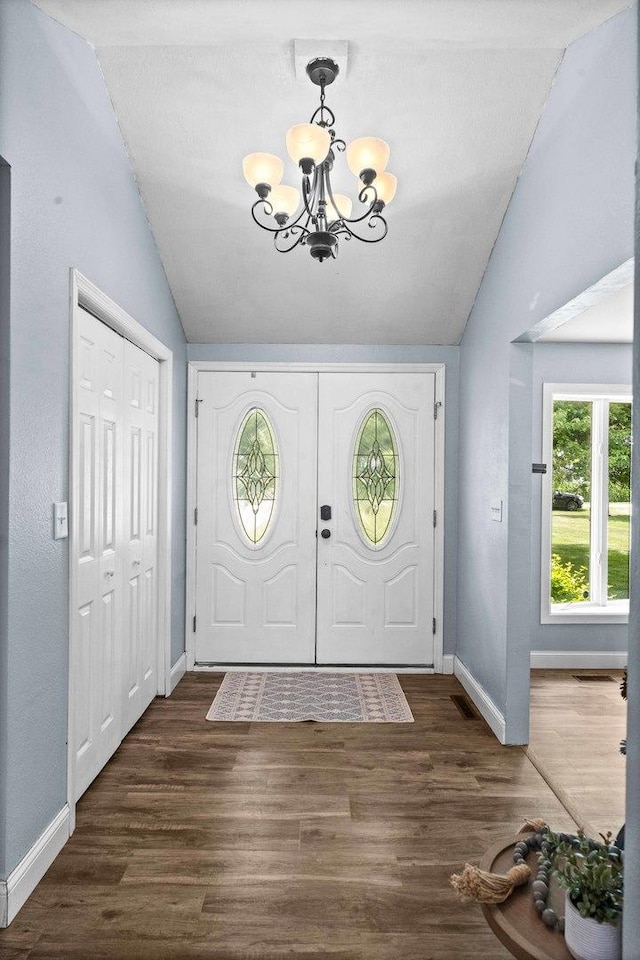 1106 Countryside Ln, Pontiac, IL 61764 - entryway with lofted ceiling, a chandelier, and wood finished floors