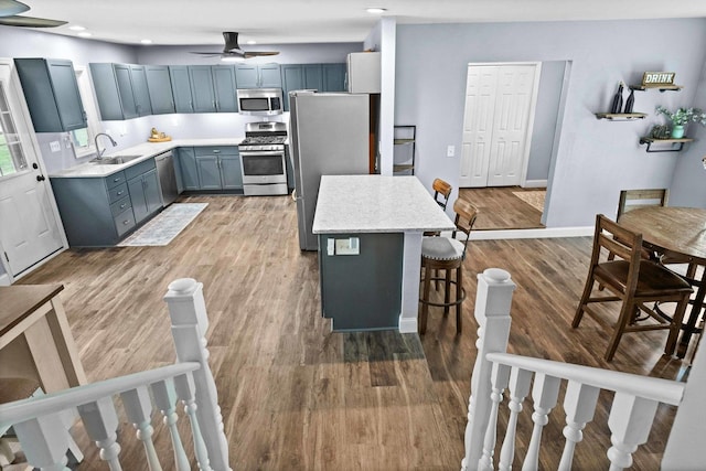 1106 Countryside Ln, Pontiac, IL 61764 - kitchen featuring appliances with stainless steel finishes, a kitchen bar, light countertops, light wood-style floors, and recessed lighting
