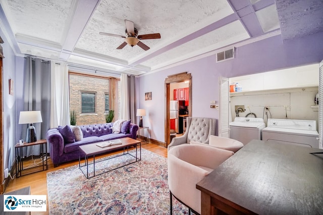 945 E Hyde Park Blvd Unit 2, Chicago, IL 60615 - living area featuring ceiling fan, light wood-style floors, washing machine and dryer, coffered ceiling, and beam ceiling