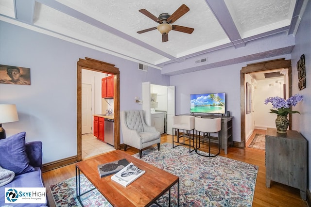 945 E Hyde Park Blvd Unit 2, Chicago, IL 60615 - living room with beamed ceiling, a ceiling fan, light wood-style flooring, and a textured ceiling