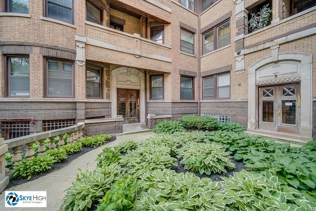 945 E Hyde Park Blvd Unit 2, Chicago, IL 60615 - view of exterior entry featuring french doors and brick siding