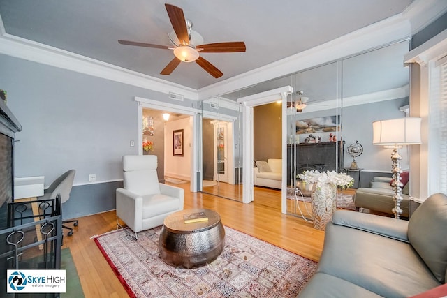 945 E Hyde Park Blvd Unit 2, Chicago, IL 60615 - living room featuring ceiling fan, wood finished floors, and ornamental molding