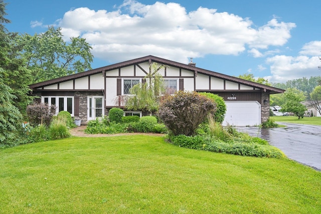 42280 N Center St, Antioch, IL 60002 - view of front of house with driveway, a garage, a front lawn, and a chimney