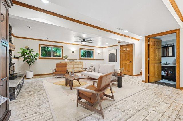 42280 N Center St, Antioch, IL 60002 - living room featuring light wood-type flooring, crown molding, recessed lighting, a ceiling fan, and stairs
