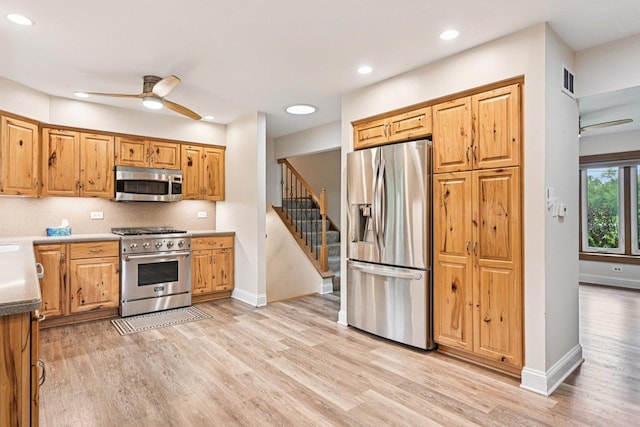 42280 N Center St, Antioch, IL 60002 - kitchen featuring appliances with stainless steel finishes, a ceiling fan, light wood-style flooring, recessed lighting, and brown cabinets