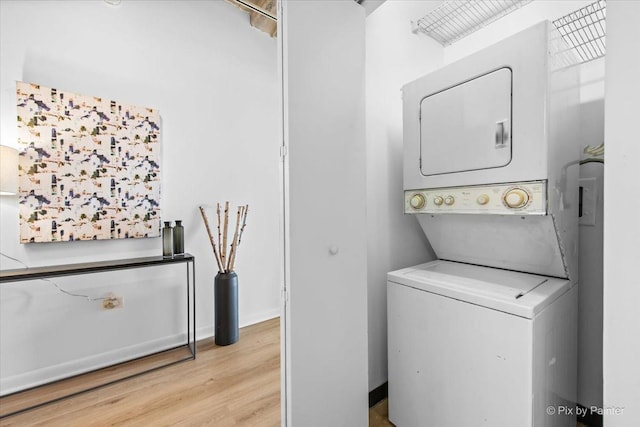 1550 S Blue Island Ave Unit 822, Chicago, IL 60608 - washroom with stacked washer and clothes dryer and light wood-style flooring