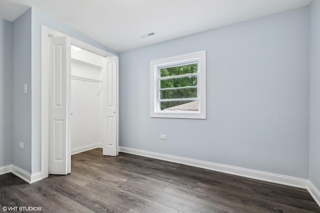 629 E 87th Pl, Chicago, IL 60619 - unfurnished bedroom featuring dark wood finished floors and a closet
