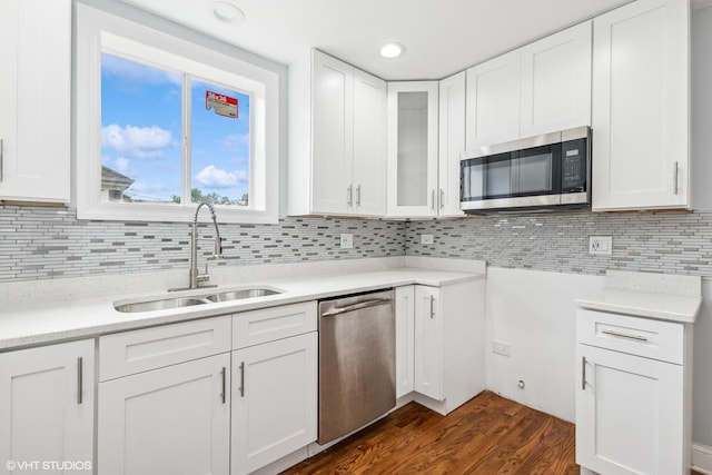 629 E 87th Pl, Chicago, IL 60619 - kitchen with appliances with stainless steel finishes, white cabinets, tasteful backsplash, dark wood-style flooring, and glass insert cabinets