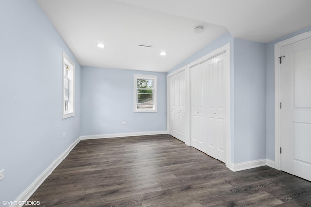 629 E 87th Pl, Chicago, IL 60619 - unfurnished bedroom with dark wood-type flooring, recessed lighting, and multiple closets