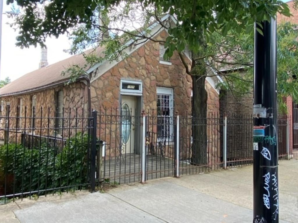 1809 W 21st St, Chicago, IL 60608 - view of front of home featuring stone siding, a fenced front yard, and a gate
