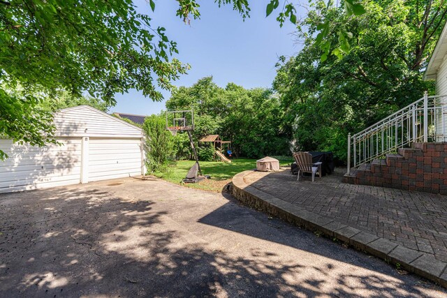 29 Oak Ridge Ave, Hillside, IL 60162 - view of patio / terrace featuring a playground, an outbuilding, stairway, and a detached garage