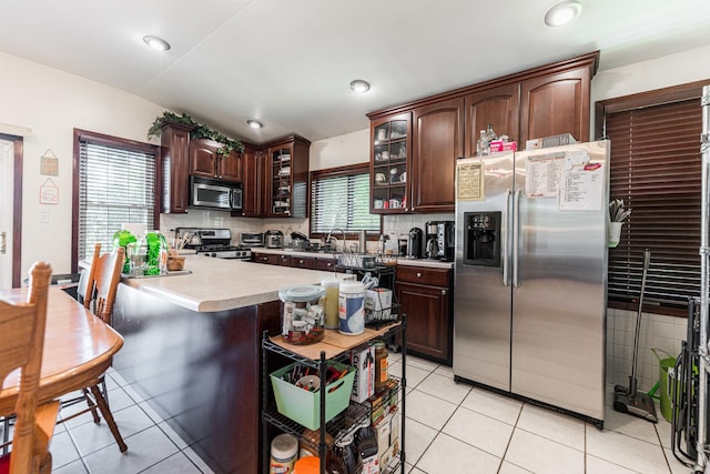 29 Oak Ridge Ave, Hillside, IL 60162 - kitchen featuring stainless steel appliances, backsplash, light tile patterned floors, and light countertops