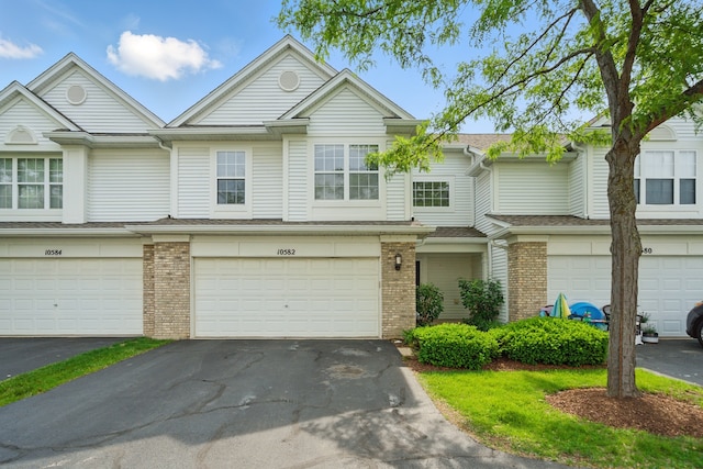 10582 Scott Dr, Huntley, IL 60142 - view of property with brick siding, driveway, and a garage