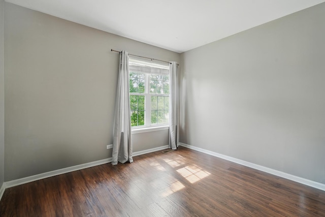 10582 Scott Dr, Huntley, IL 60142 - unfurnished room with baseboards and dark wood-type flooring