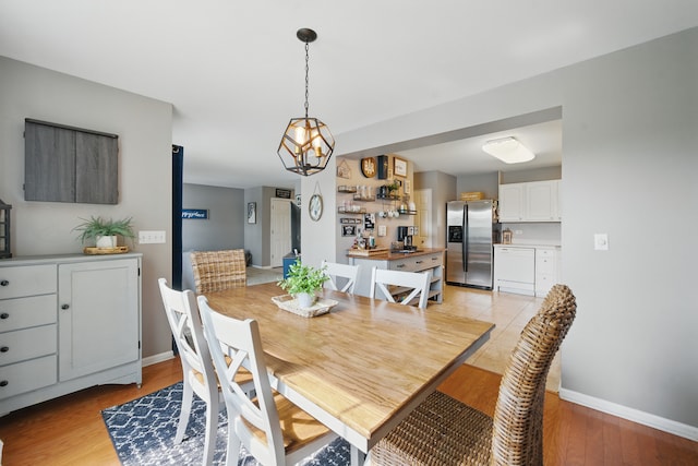 10582 Scott Dr, Huntley, IL 60142 - dining area featuring light wood finished floors and a chandelier