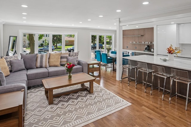 4546 Howard St, Skokie, IL 60076 - living room with crown molding, light wood-style floors, and recessed lighting