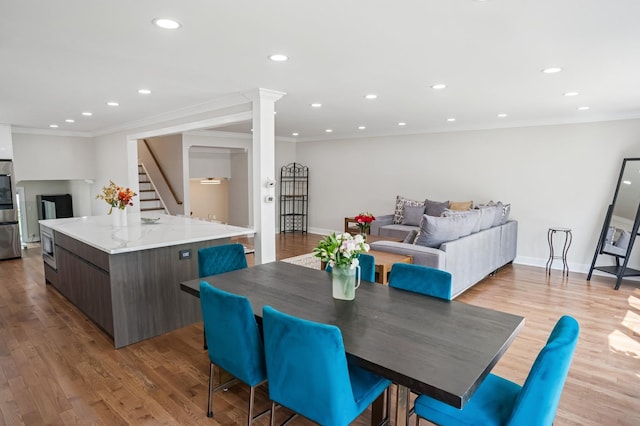 4546 Howard St, Skokie, IL 60076 - dining area featuring stairway, ornamental molding, light wood-type flooring, and recessed lighting
