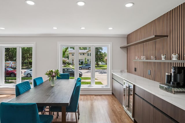 4546 Howard St, Skokie, IL 60076 - dining space with wine cooler, healthy amount of natural light, light wood finished floors, recessed lighting, and ornamental molding