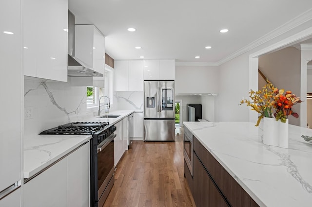 4546 Howard St, Skokie, IL 60076 - kitchen featuring modern cabinets, stainless steel appliances, white cabinets, light wood finished floors, and wall chimney exhaust hood