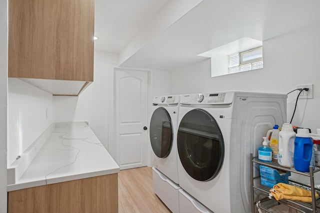 4546 Howard St, Skokie, IL 60076 - laundry area featuring cabinet space, independent washer and dryer, and light wood-type flooring