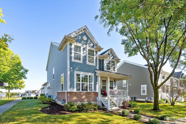1266 Airs Ave, Sugar Grove, IL 60554 - view of front of property featuring brick siding, a porch, a front yard, and stairs