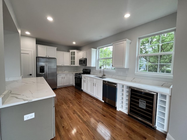 1266 Airs Ave, Sugar Grove, IL 60554 - kitchen with appliances with stainless steel finishes, wine cooler, dark wood-type flooring, light stone countertops, and recessed lighting