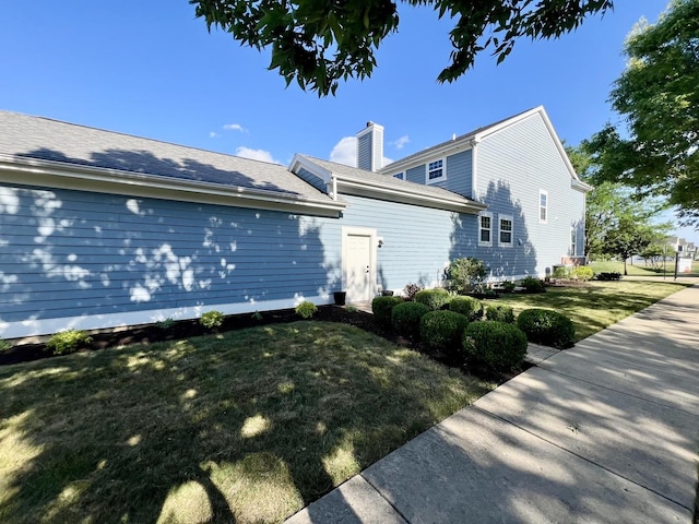 1266 Airs Ave, Sugar Grove, IL 60554 - view of property exterior featuring a lawn and a chimney