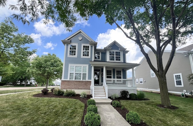 1266 Airs Ave, Sugar Grove, IL 60554 - view of front facade with covered porch, a front lawn, brick siding, and stairway