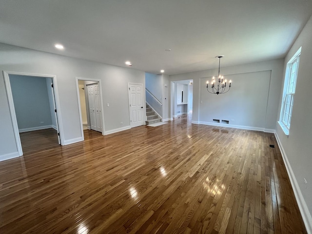 1266 Airs Ave, Sugar Grove, IL 60554 - unfurnished living room with a chandelier, dark wood-style floors, stairway, and recessed lighting