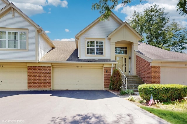 434 Cromwell Cir Unit 3, Bartlett, IL 60103 - view of front of property featuring driveway, brick siding, a shingled roof, and an attached garage